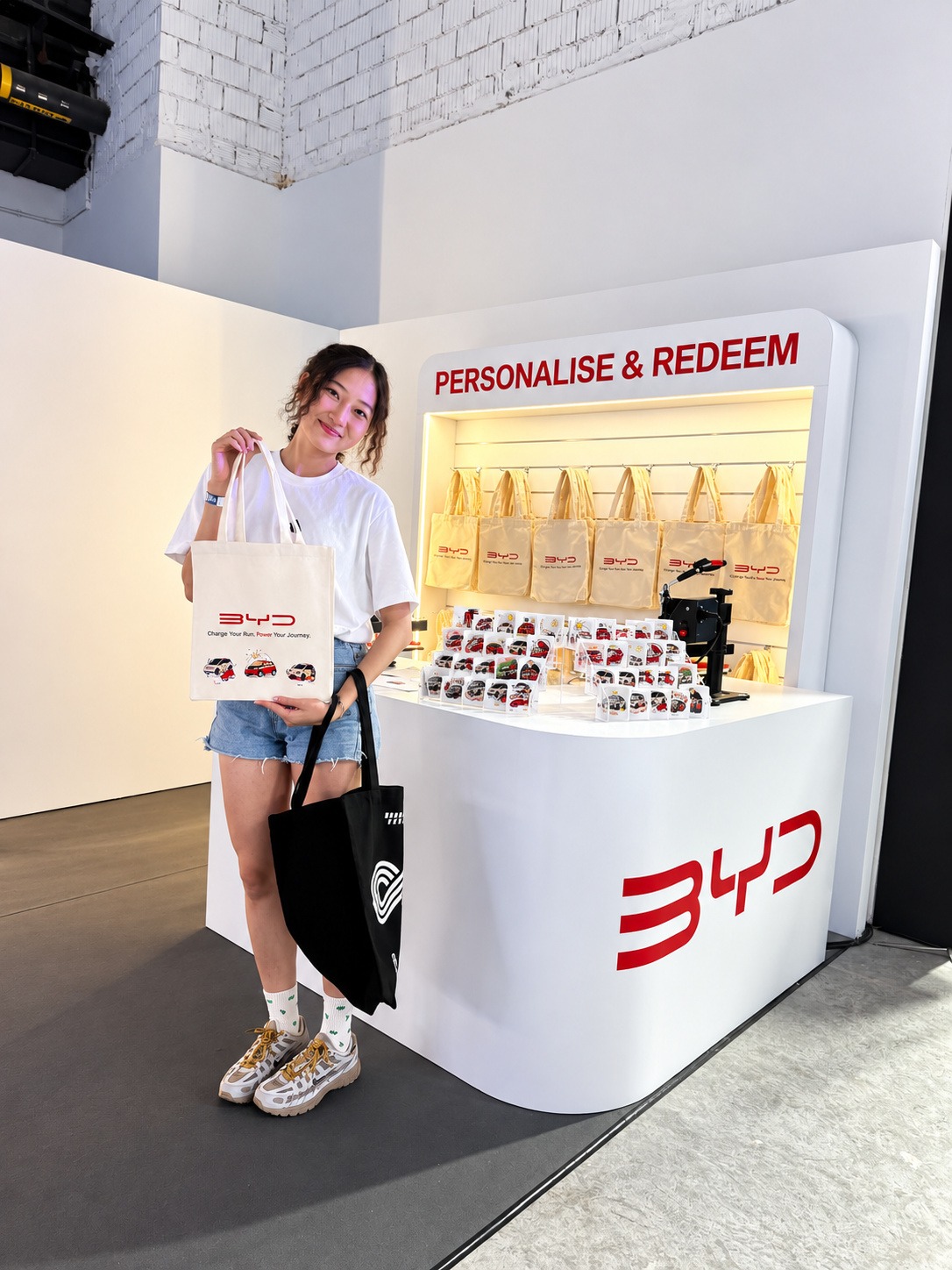 Guest holding a personalised canvas tote bag at a Custom Tote Bag Fringe Activity booth