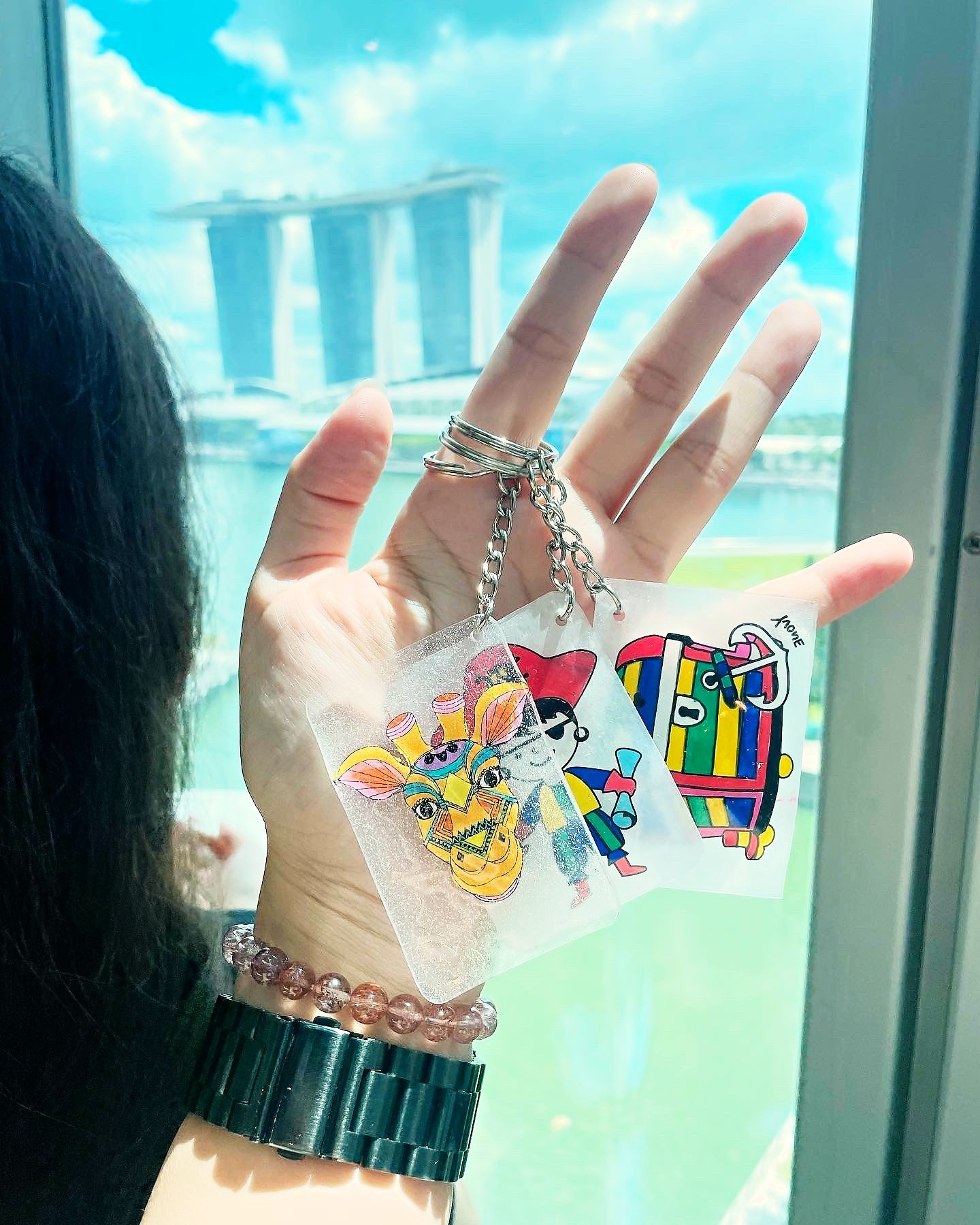 Finished shrink art keychains displayed in a hand
