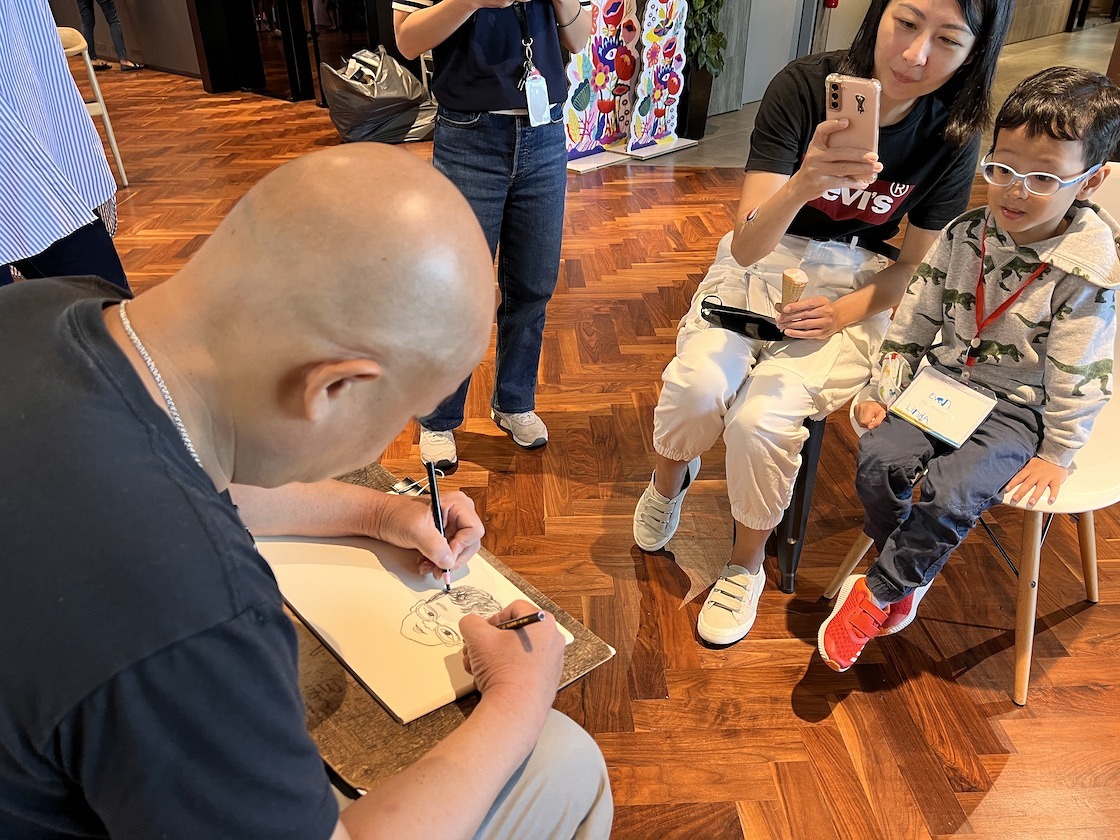 Caricature artist drawing a family portrait at an event