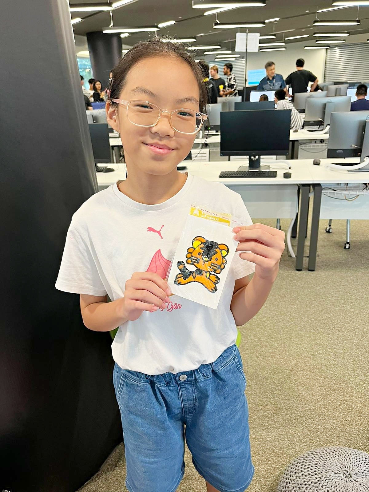 Participant holding completed window art